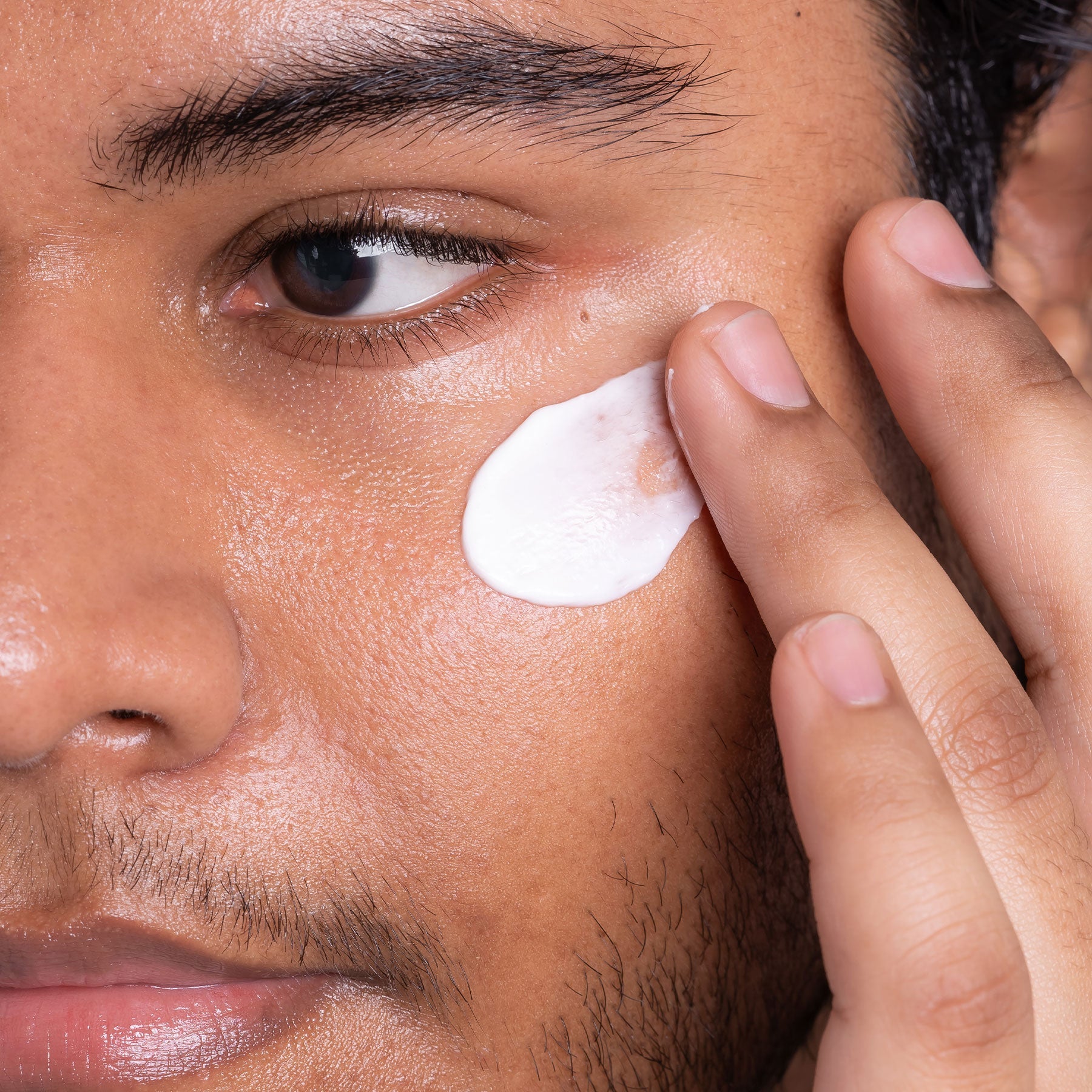 Man applying Indie Lee Retinol Alternative Cream to his face