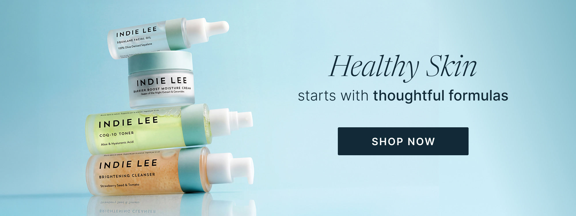 Four Indie Lee skincare products are stacked vertically on a light blue background with promotional text.
