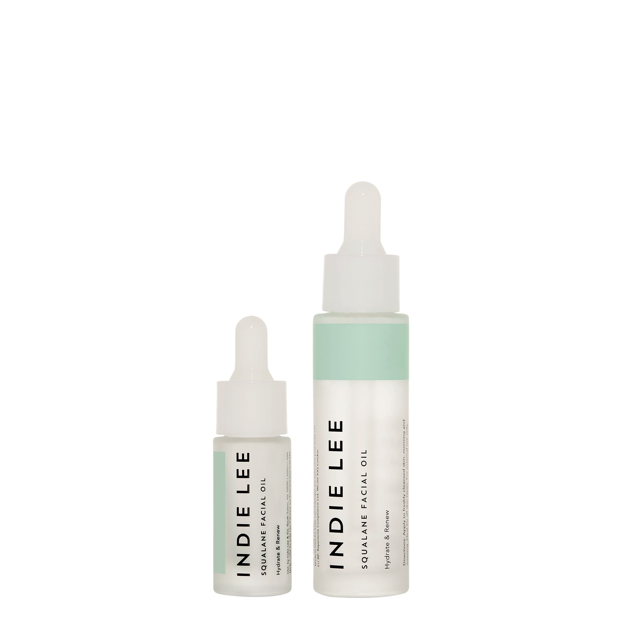 Two bottles of Indie Lee Squalane Ffacial Oil on a white background