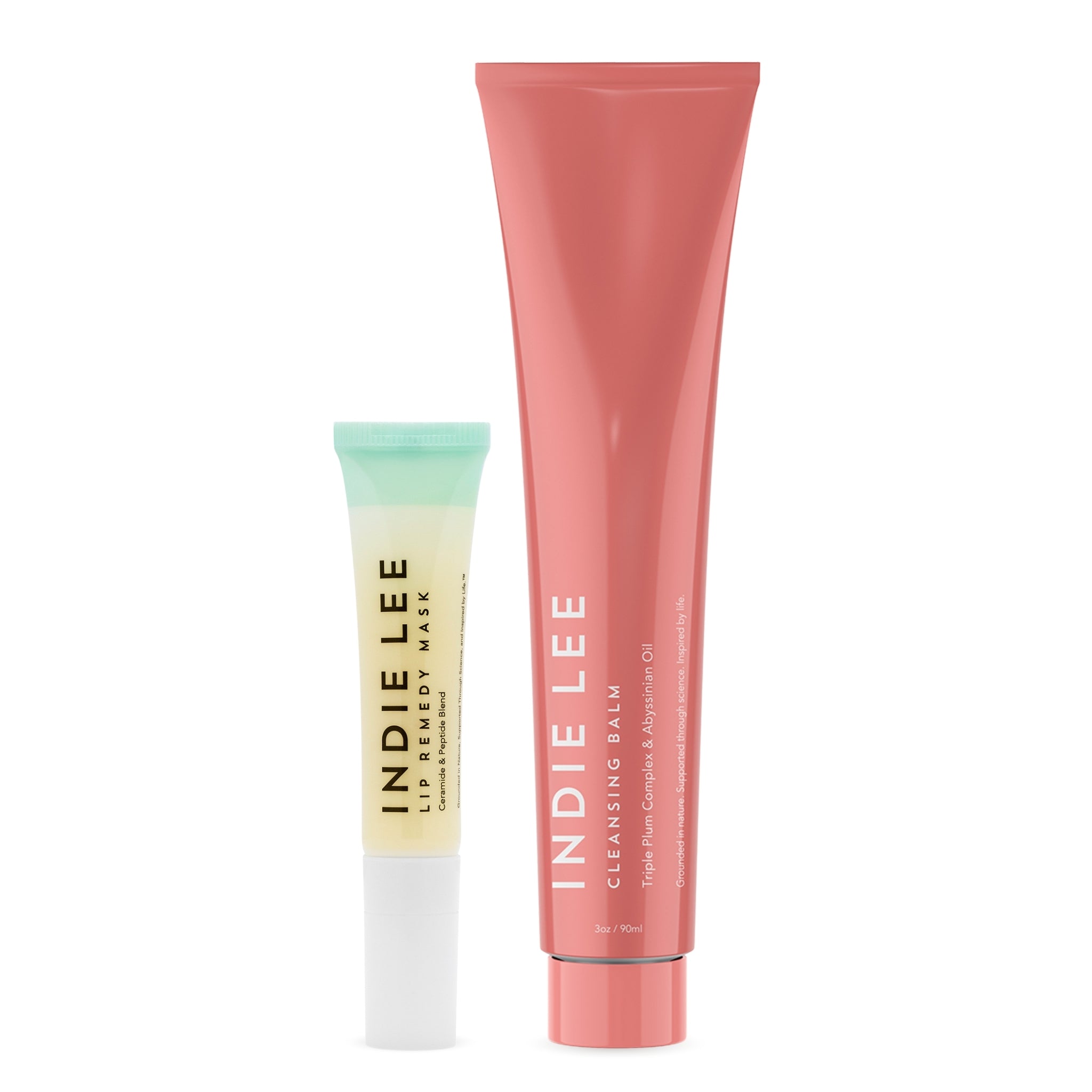 Indie Lee Lip Remedy Mask and Cleansing Balm on a gradient background