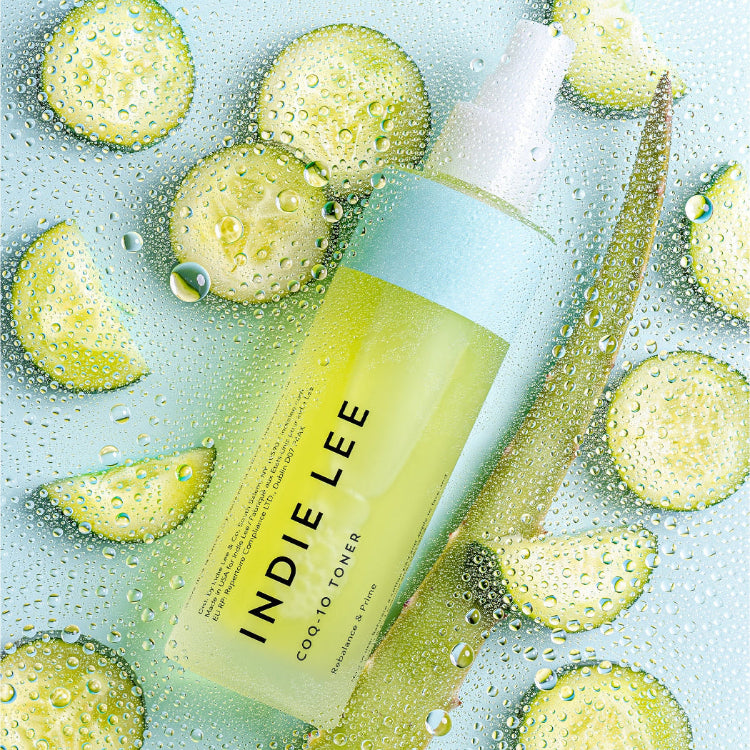 CoQ-10 Toner on a light blue background with cucumber slices and aloe