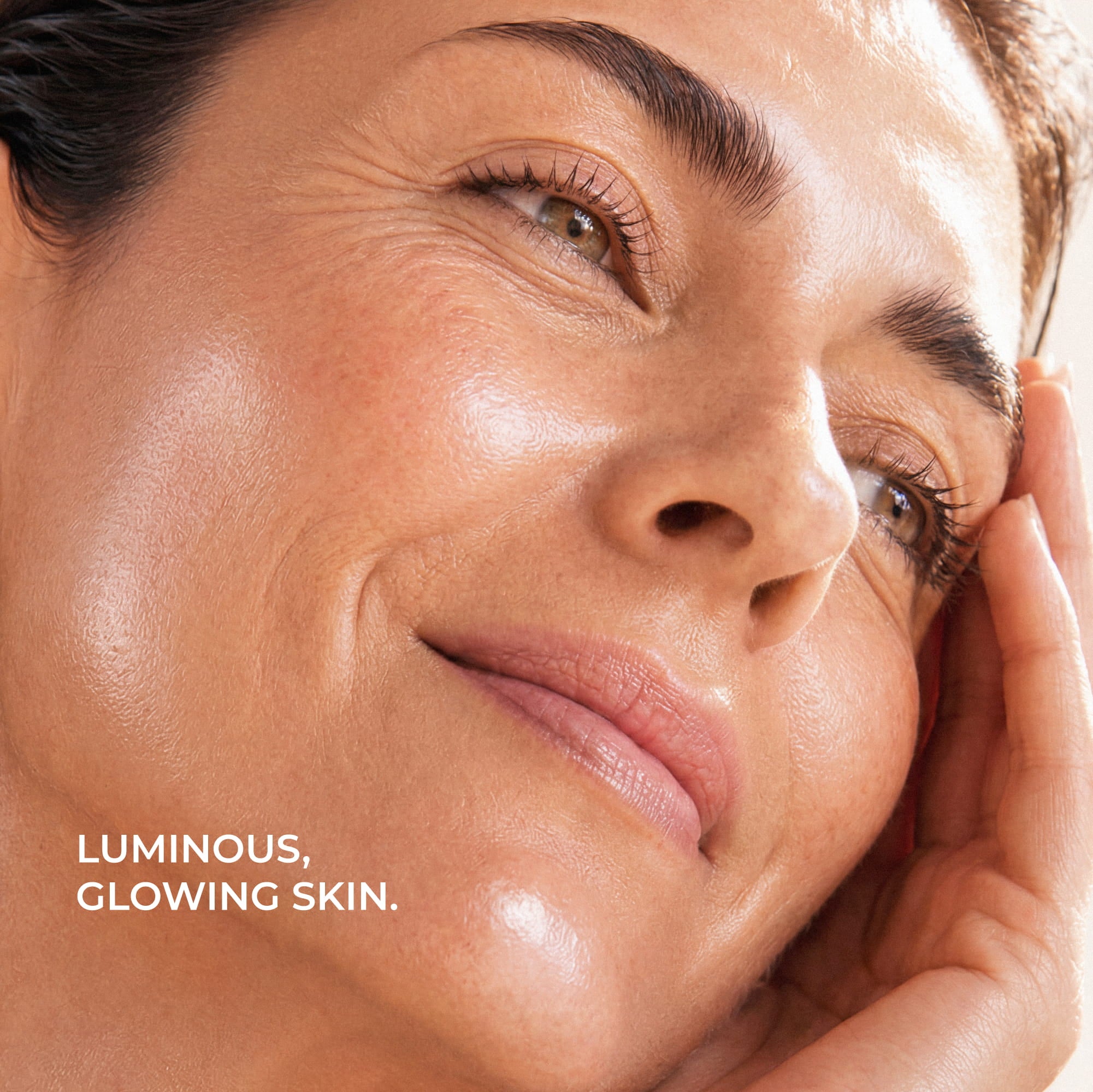 Close-up of a woman's face with the text 'LUMINOUS, GLOWING SKIN.' in the lower left corner.
