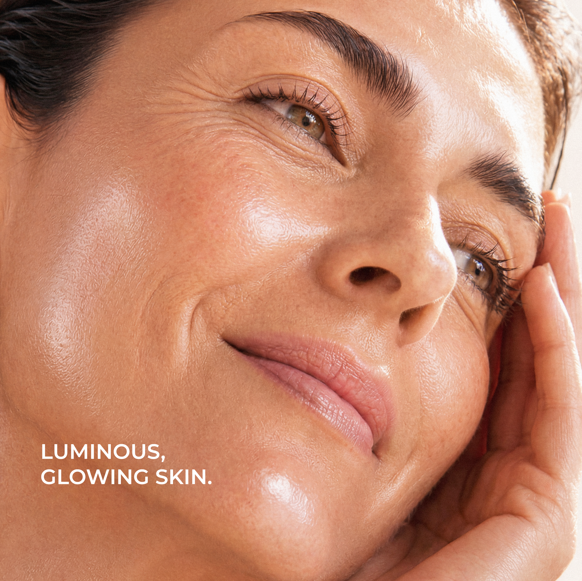 Close-up of a woman's face with the text 'LUMINOUS, GLOWING SKIN.' in the lower left corner.