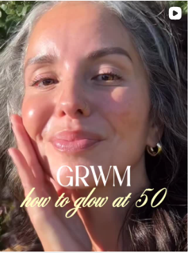 Woman with text 'GRWM how to glow at 50' on a blurred natural background