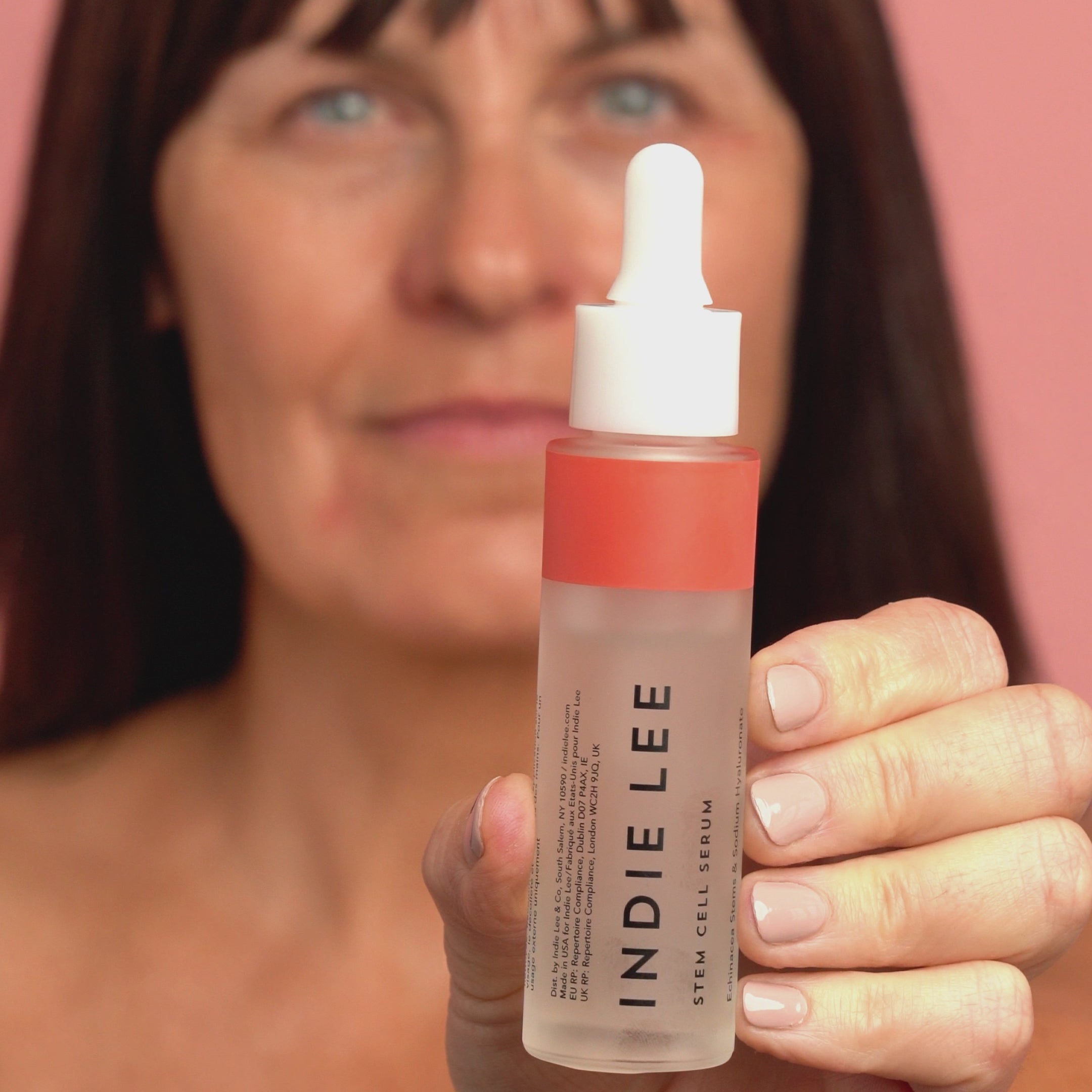 Woman applying Indie Lee Stem Cell Serum